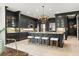 Expansive kitchen boasts granite countertops, dark cabinetry, pendant lighting, and stainless appliances at 15007 Laurel Cove Cir, Odessa, FL 33556