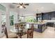 Bright kitchen with dark cabinets, granite countertops, a central island, and an eat-in nook at 15007 Laurel Cove Cir, Odessa, FL 33556