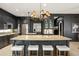 Spacious kitchen island features stone countertops, seating, and modern fixtures at 15007 Laurel Cove Cir, Odessa, FL 33556