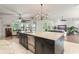 Kitchen island with seating offers modern appliances, stylish cabinetry and bright light at 15007 Laurel Cove Cir, Odessa, FL 33556