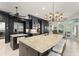 Large kitchen island with bar seating, stone countertops, stainless steel appliances, and black cabinets at 15007 Laurel Cove Cir, Odessa, FL 33556