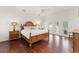 Bright main bedroom features wood floors, ceiling fan and a private balcony at 15007 Laurel Cove Cir, Odessa, FL 33556