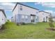 Well-maintained backyard with lush green grass, a new tree, and light blue siding at 3544 Moscato Dr, Brooksville, FL 34602