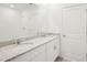 Elegant bathroom featuring double sink vanity, granite countertops, and a large mirror at 3544 Moscato Dr, Brooksville, FL 34602