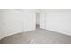 This bedroom features neutral carpeting and a white closet at 3544 Moscato Dr, Brooksville, FL 34602