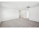 Spacious bedroom with neutral carpet and a doorway at 3544 Moscato Dr, Brooksville, FL 34602