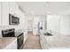 Modern kitchen with white cabinets, stainless steel appliances, and granite countertops at 3544 Moscato Dr, Brooksville, FL 34602