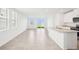 Open-concept living area with bright windows, ceramic tile floors and kitchen island at 3544 Moscato Dr, Brooksville, FL 34602