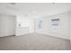 Bright and spacious open-plan living room with large windows and gray carpet at 3544 Moscato Dr, Brooksville, FL 34602