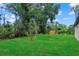 Lush backyard with mature trees and green grass at 3913 Eagle Pass St, North Port, FL 34286