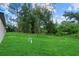 Expansive backyard with well-maintained lawn and young trees at 3913 Eagle Pass St, North Port, FL 34286