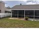 View of screened-in lanai with stone paver flooring and fenced yard at 1403 Ventana Dr, Sun City Center, FL 33573