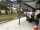 Covered and screened-in patio featuring outdoor seating with golf course views at 1403 Ventana Dr, Sun City Center, FL 33573