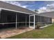 View of screened-in lanai with stone paver flooring at 1403 Ventana Dr, Sun City Center, FL 33573