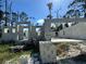 New construction of a cinder block home with concrete foundation and surrounding wooded area at 18141 Spartonvail Ave, Port Charlotte, FL 33954