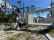 Exterior view of cinder block home construction with concrete foundation, surrounded by vegetation at 18141 Spartonvail Ave, Port Charlotte, FL 33954