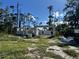 Exterior view of a new home concrete block foundation and concrete slab on a wooded lot at 18141 Spartonvail Ave, Port Charlotte, FL 33954