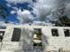 Image of a new block foundation with window and door openings under a cloudy, blue sky at 18141 Spartonvail Ave, Port Charlotte, FL 33954