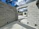 View through block walls and doorway of the concrete slab foundation for new home construction at 18141 Spartonvail Ave, Port Charlotte, FL 33954