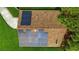 Aerial view of a brown shingle roof with solar panels at 1300 Pleasant S Way, St Petersburg, FL 33705