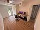 Bright bedroom featuring wood floors, ceiling fan, glass doors, and modern computer setup at 1300 Pleasant S Way, St Petersburg, FL 33705