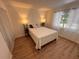 This bedroom features hardwood floors and two bedside lamps at 1300 Pleasant S Way, St Petersburg, FL 33705