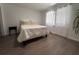 Simple bedroom with wood floors, a bed, and natural light from a window at 1300 Pleasant S Way, St Petersburg, FL 33705