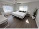 Bright bedroom with a large bed, sheer curtains, and wood flooring at 1300 Pleasant S Way, St Petersburg, FL 33705