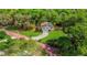 Aerial view of a two-story home with a driveway and lush green landscaping surrounding the property at 1300 Pleasant S Way, St Petersburg, FL 33705