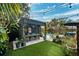 Outdoor dining area and artificial turf create an inviting backyard for relaxation and entertainment at 132 17Th N Ave, St Petersburg, FL 33704