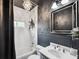 Bathroom features decorative wainscotting, a chandelier, and a gray vanity at 132 17Th N Ave, St Petersburg, FL 33704