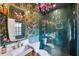 Stylish bathroom with bold wallpaper, a modern vanity, and a glass-enclosed shower at 132 17Th N Ave, St Petersburg, FL 33704