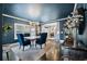 Stylish dining room with dark blue walls, a modern chandelier, and hardwood floors at 132 17Th N Ave, St Petersburg, FL 33704