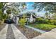 Charming single-Gathering home with a driveway and a manicured front lawn with mature trees at 132 17Th N Ave, St Petersburg, FL 33704
