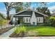 Inviting single-Gathering home featuring a landscaped front yard, a white brick chimney, and beautiful architectural details at 132 17Th N Ave, St Petersburg, FL 33704