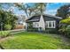 Well-kept home showcasing a green lawn, a charming walkway, and a white brick chimney at 132 17Th N Ave, St Petersburg, FL 33704