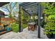 Charming outdoor dining area with pergola, creating a serene space for relaxation and entertaining at 132 17Th N Ave, St Petersburg, FL 33704