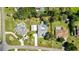 Aerial view of property showcasing a large lot, swimming pool, car port, and well-manicured lawn at 13295 Don Loop, Spring Hill, FL 34609