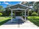 Outdoor BBQ area featuring a built-in bar, lighting, and green surroundings at 13295 Don Loop, Spring Hill, FL 34609