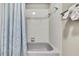 Bathroom featuring a shower and tub with white tiles and blue shower curtain at 13295 Don Loop, Spring Hill, FL 34609
