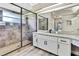 Bathroom featuring a glass shower and vanity with granite countertops, complemented by gray walls and tile at 13295 Don Loop, Spring Hill, FL 34609