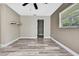 Neutral bedroom features wood-look flooring, shelf and a bright window at 13295 Don Loop, Spring Hill, FL 34609