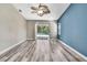 Spacious bedroom with sliding glass doors to the pool, features a contemporary ceiling fan, and wood-style flooring at 13295 Don Loop, Spring Hill, FL 34609