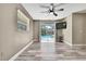 Bright bedroom with access to a screened in pool area, luxury vinyl flooring, and natural light at 13295 Don Loop, Spring Hill, FL 34609