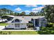 Charming single-Gathering home with manicured lawn, mature trees, and covered parking at 13295 Don Loop, Spring Hill, FL 34609