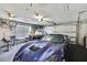 Spacious garage with two cars, bicycles, and a workbench with stools at 13295 Don Loop, Spring Hill, FL 34609