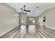 Bright living room boasts vaulted ceiling, modern ceiling fan, and attractive wood-look floors at 13295 Don Loop, Spring Hill, FL 34609
