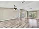Spacious living area features high ceilings, wood-look floors, and an abundance of natural light at 13295 Don Loop, Spring Hill, FL 34609