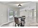 Living room seating area with barstool table, French doors, and views of the screened in pool area at 13295 Don Loop, Spring Hill, FL 34609