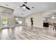 Bright living area features wood-look floors, a high ceiling, and an abundance of natural light at 13295 Don Loop, Spring Hill, FL 34609